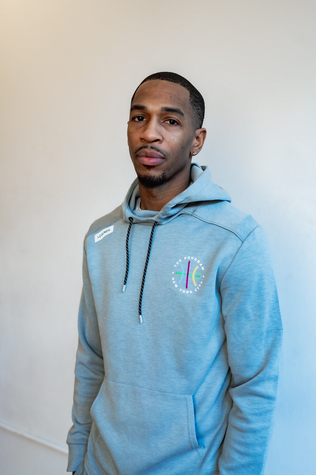 Photo of a guy wearing the Program NYC heather grey hoodie