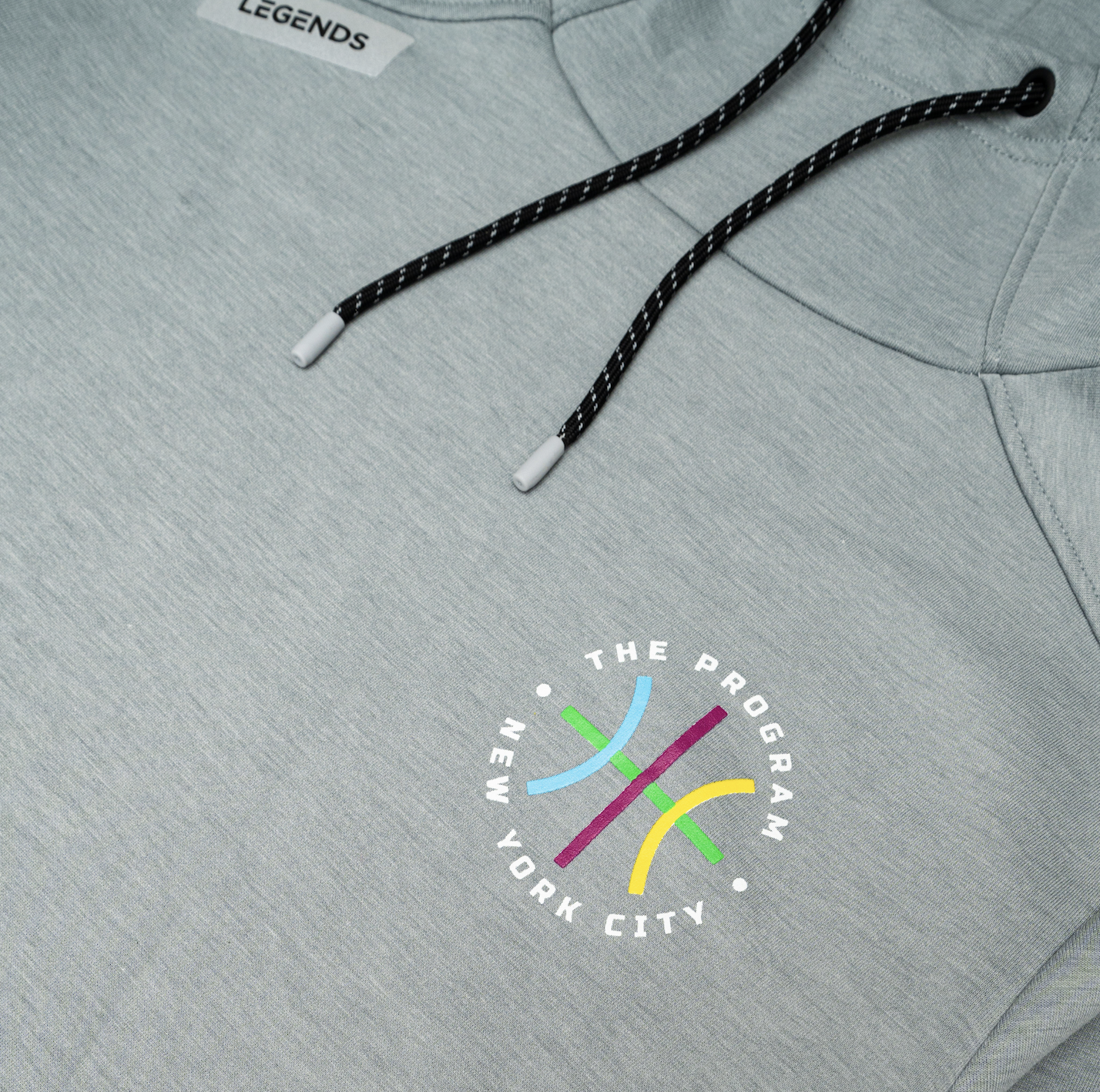 Closeup shot of the The Program NYC logo on the The Program NYC heather grey hoodie