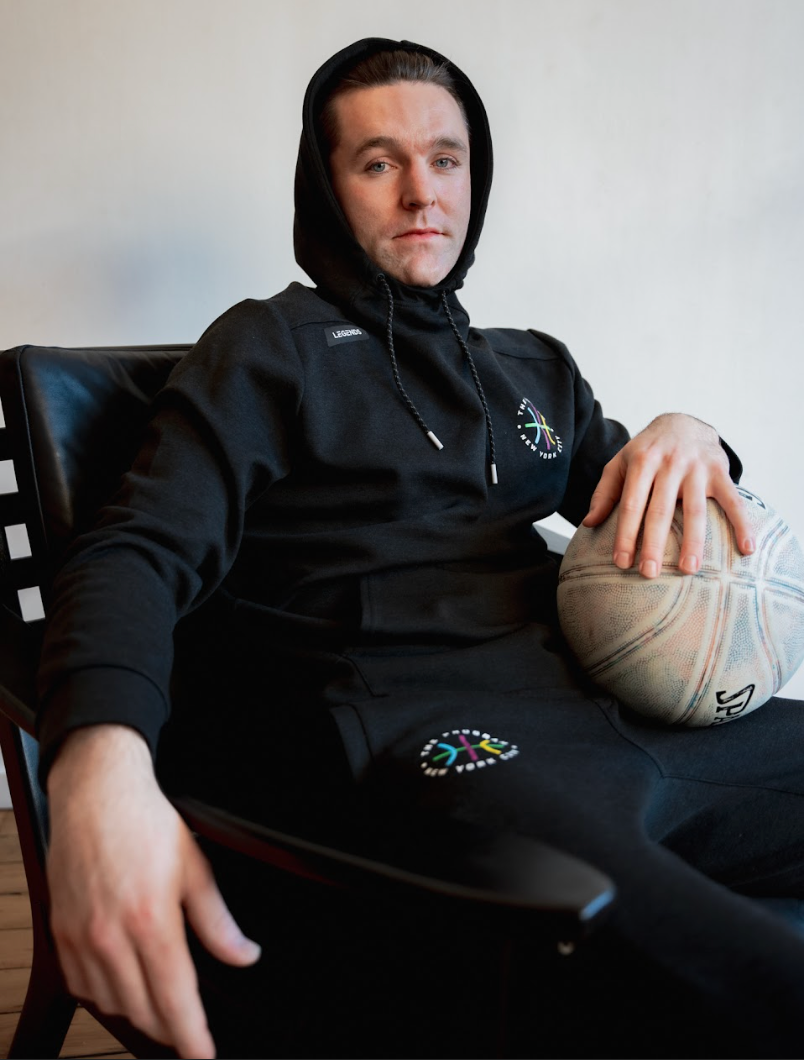 Photo of a basketball player wearing the The Program NYC black hoodie